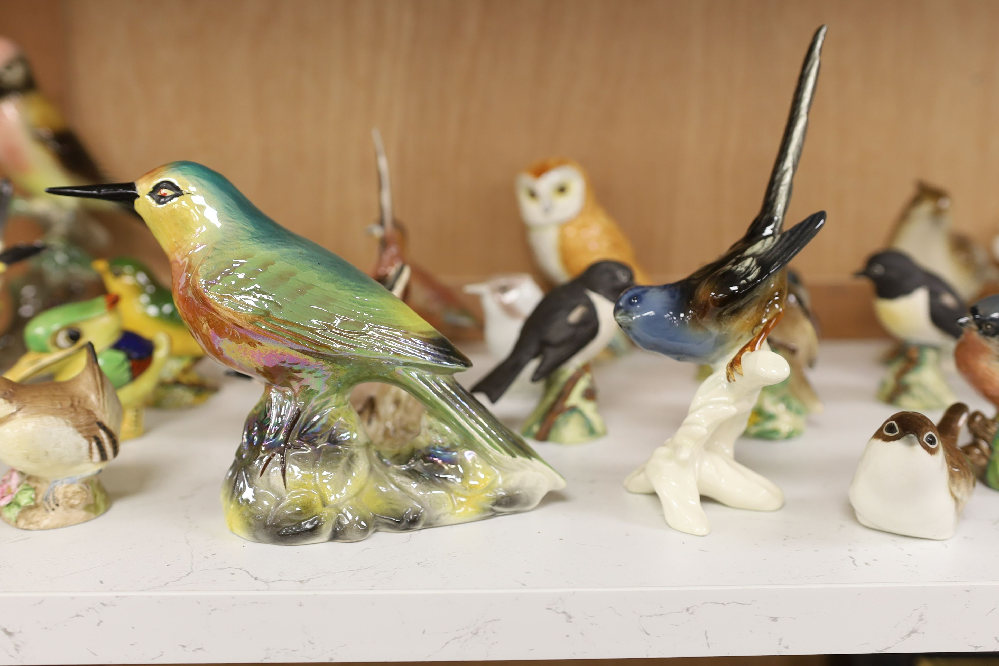 A large collection of ceramic bird figures including Beswick, Russian models, Karl Ens etc